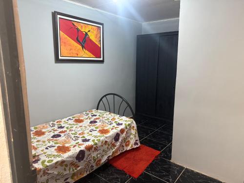 a bedroom with a bed and a picture on the wall at La comodidad a su alcance in La Cuesta
