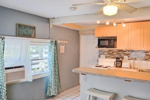 a kitchen with a counter and a window at Shortboard in Holmes Beach