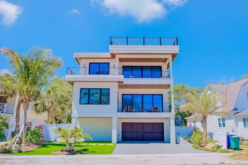 a large house with palm trees in front of it at Gulf View Estate in Anna Maria