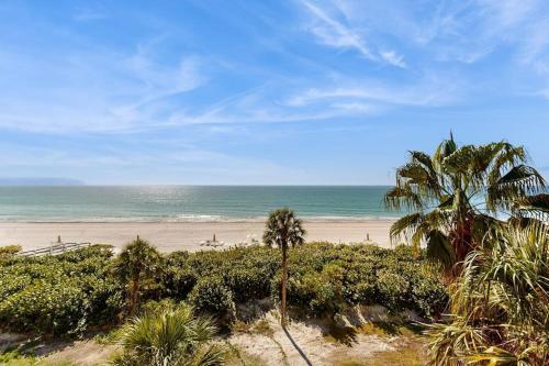 a beach with palm trees and the ocean at Island Time Hideaway in Longboat Key