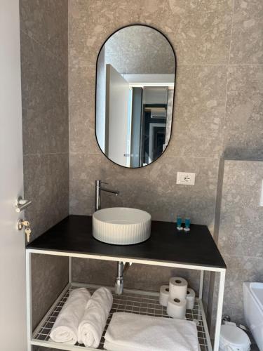 a bathroom with a sink and a mirror at NOOR Boutique Hotel in Koplik