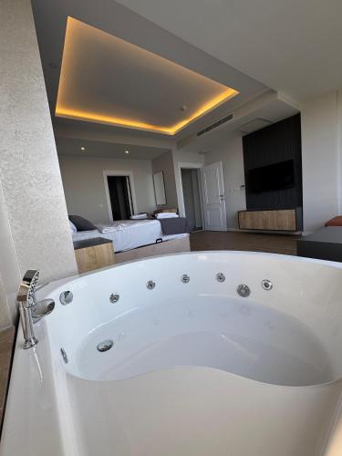 a large white bath tub in a room at North Star Resort Hotel in Of
