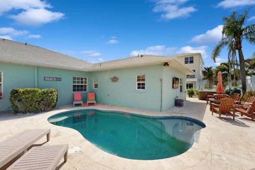 a swimming pool in front of a house at King Crab in Holmes Beach