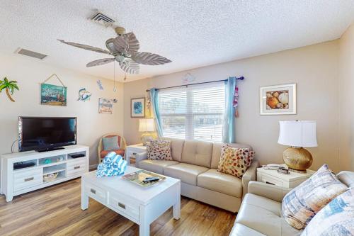 a living room with a couch and a tv at The Villas, Condo 1A in Holmes Beach