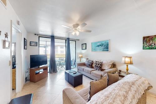 a living room with a couch and a flat screen tv at Shorewalk 103 in Bradenton