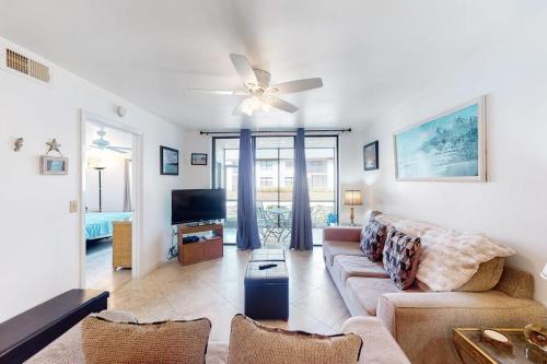 a living room with a couch and a tv at Shorewalk 103 in Bradenton