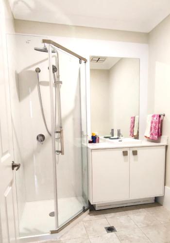 a bathroom with a shower and a sink at The Fifth Season in Unanderra