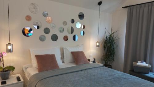a bedroom with a bed and some plates on the wall at Chalet Terra Transfăgărășan in Cerbureni
