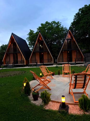 a group of chairs sitting in front of a house at Rivendell Vardzia in T'mogvi
