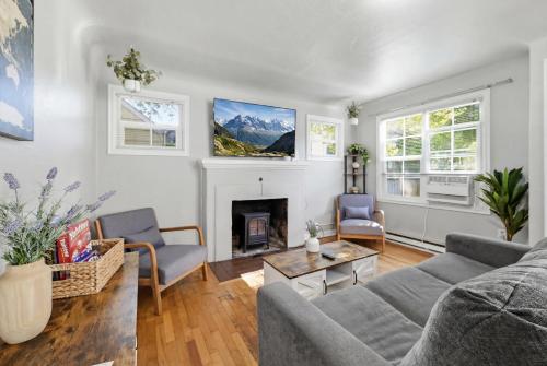 a living room with a couch and a fireplace at Charming 1930s Style Rustic Home in Eugene