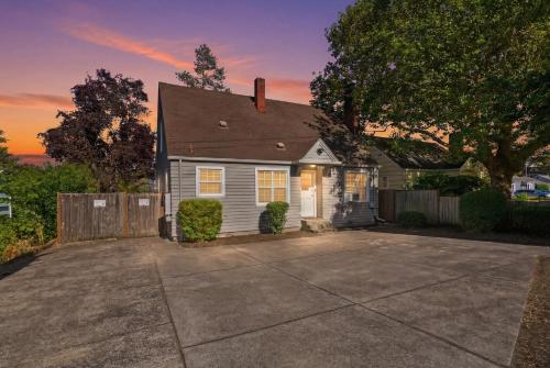 a house with a driveway in front of it at Charming 1930s Style Rustic Home in Eugene