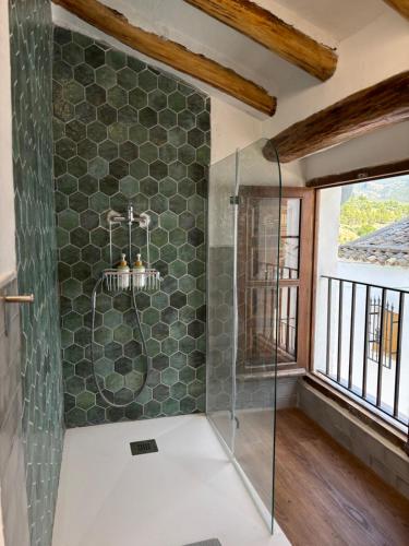 a bathroom with a shower with a glass door at El Rincón de Laura - Quesada in Quesada