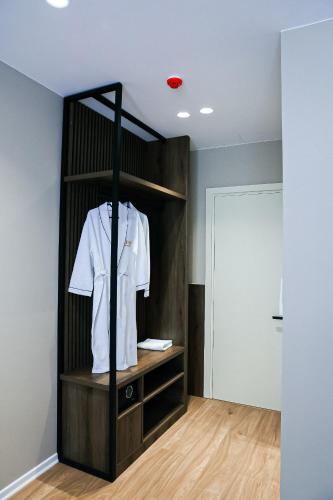 a white shirt on a rack in a room at Oribu Boutique Hotel Vlore in Vlorë