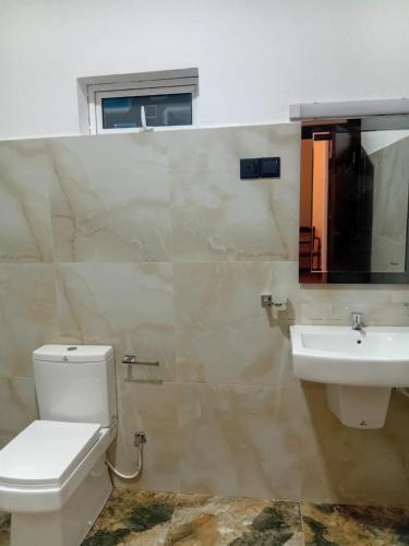 a bathroom with a toilet and a sink at 7C Villa in Galle