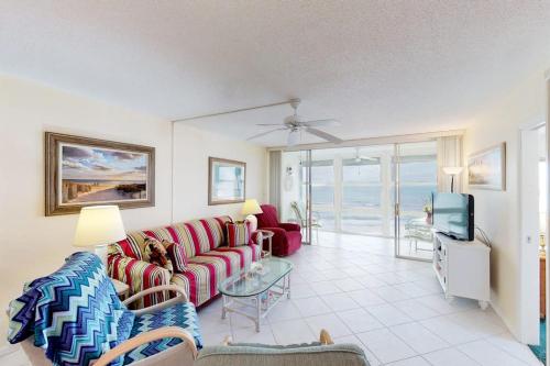 a living room with a couch and a tv at Martinique 401S in Holmes Beach