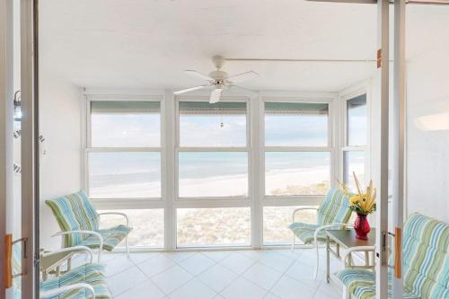 a living room with chairs and a large window at Martinique 401S in Holmes Beach