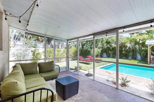 a living room with a couch and a swimming pool at Getaway on Gladiolus in Anna Maria