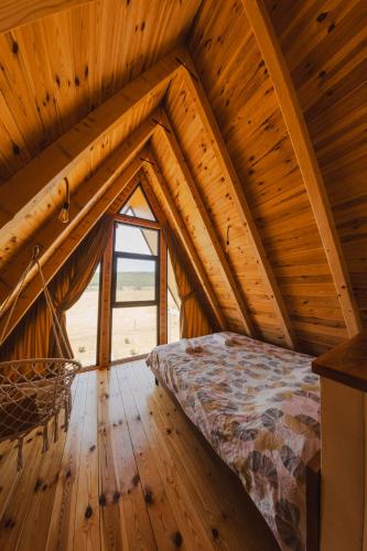a bedroom with a bed in a wooden attic at Sunrise House in Plužine