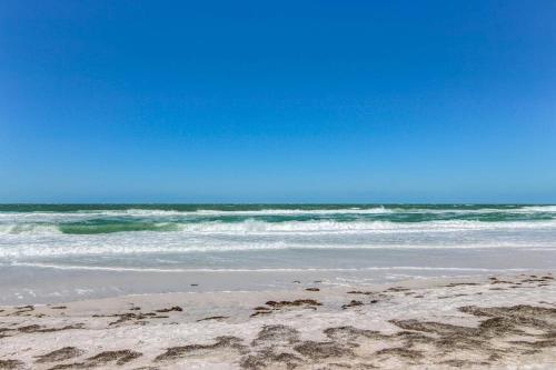 a sandy beach with the ocean in the background at Gertie's Coconut House in Holmes Beach