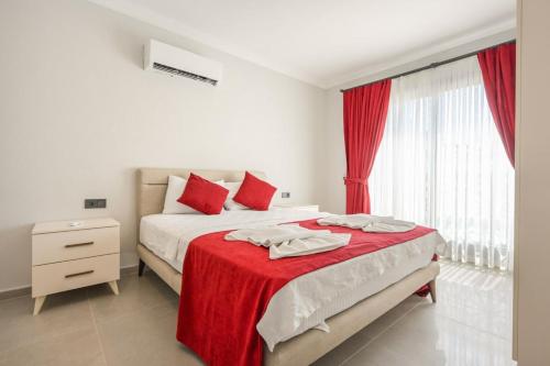 a bedroom with a bed with a red blanket at Villa A1 Canpare in Fethiye