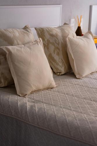 a group of pillows sitting on top of a bed at Sitios del Sol 1 in General Acha