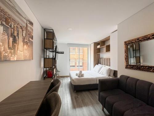 a living room with a bed and a couch at Parque de La 93 - Elite Flats in Bogotá