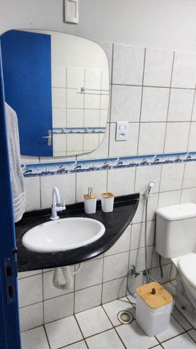 a bathroom with a sink and a toilet and a mirror at Casa Estrela Azul in Pitimbu