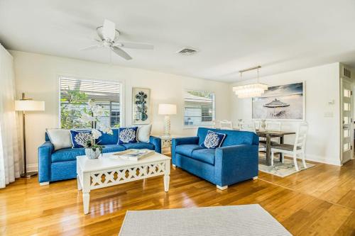 a living room with two blue couches and a table at Sandy's Getaway in Anna Maria