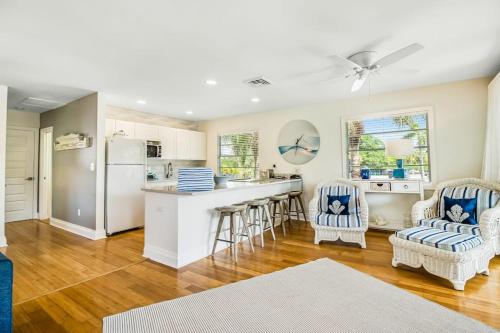 a kitchen and living room with a counter and chairs at Sandy's Getaway in Anna Maria