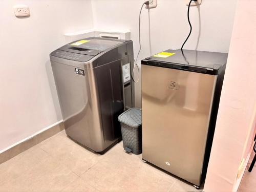 a small refrigerator and a trash can in a room at Posada del Quindío 0219 in Armenia
