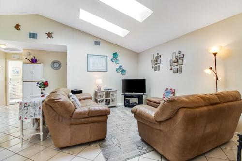 a living room with two couches and a tv at Bella Villa in Bradenton