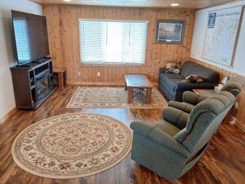 a living room with two couches and a tv at Back Bay Getaway in Hayward