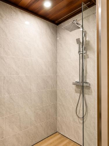 a bathroom with a shower with a glass door at The Promenade House in New Brighton