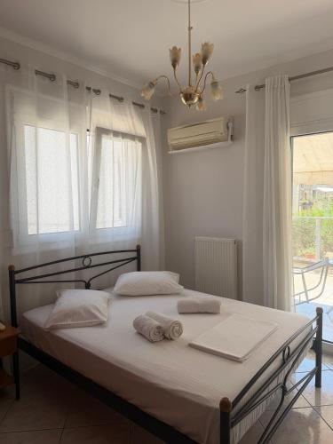 a bedroom with a bed with towels on it at Katies cozy corner in Chios