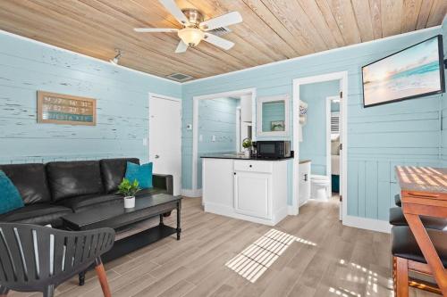 a living room with a couch and a ceiling fan at Parrot Beach Cottages Suite #4 in Siesta Key