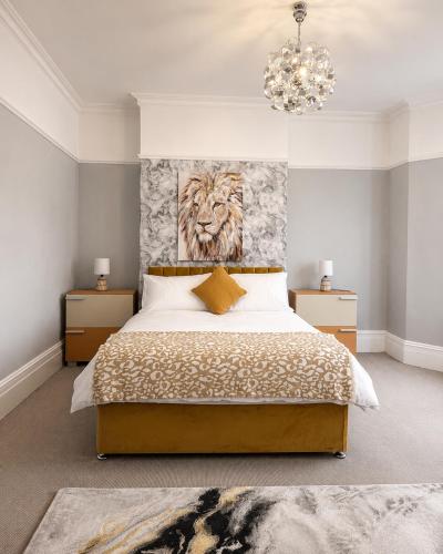 a bedroom with a bed with a lion head on the wall at The Promenade House in New Brighton