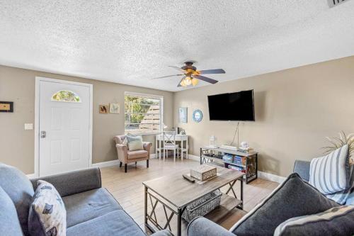 a living room with a couch and a tv at Holmes Beach Bungalow - B in Holmes Beach