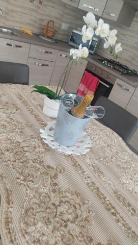 a table with a vase with glasses and flowers on it at Lary&Giù in Cadelbosco di Sopra