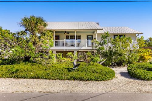a house with a statue in front of it at Sundance Cottage in Anna Maria