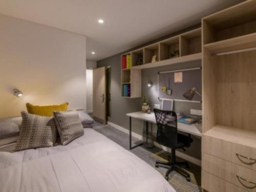 a bedroom with a bed and a desk in it at ABeleven in Aberdeen