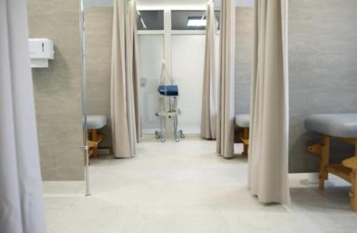 a hospital room with a row of doors and a hallway at Holiday Home Resort & Spa in Jarosławiec
