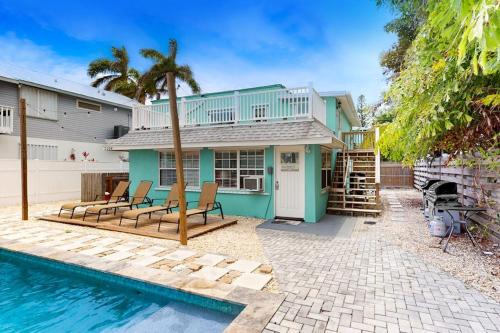 a house with a swimming pool next to a house at Breezy Bungalow A and B in Bradenton Beach