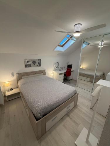 a bedroom with a bed and a mirror at L'Adresse Signature, Duplex d'Exception à Saumur in Saumur