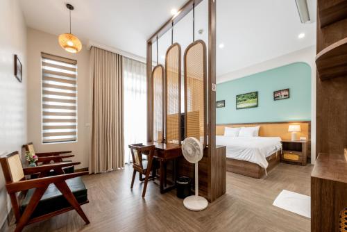 a hotel room with a bed and a desk at La May Boutique hotel in Ninh Binh