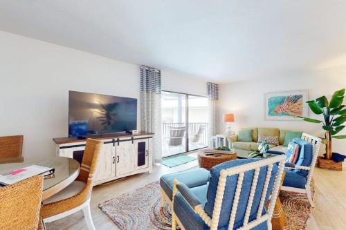 a living room with a couch and a tv at Gulf Place 20 in Holmes Beach