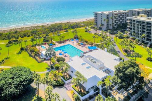 an aerial view of a resort with a pool and the beach at Paradise Time Hideaway in Longboat Key