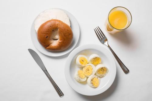 a plate of eggs and a bagel and a glass of orange juice at The Marina Inn on San Francisco Bay in San Leandro