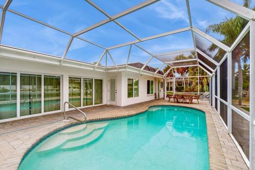 an indoor pool in a house with a glass ceiling at Poseidons Palace in Sarasota