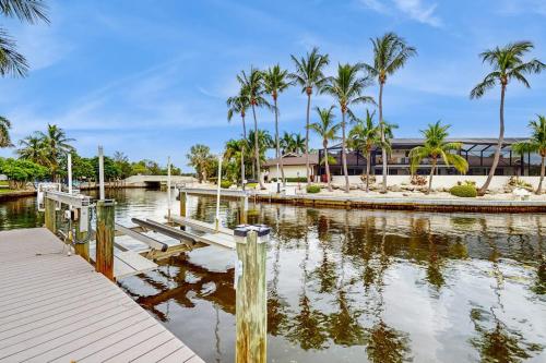 a marina with palm trees and a dock at Poseidons Palace in Sarasota