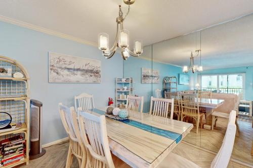 a dining room and living room with a table and chairs at Gulf Place 19 & 20 in Holmes Beach